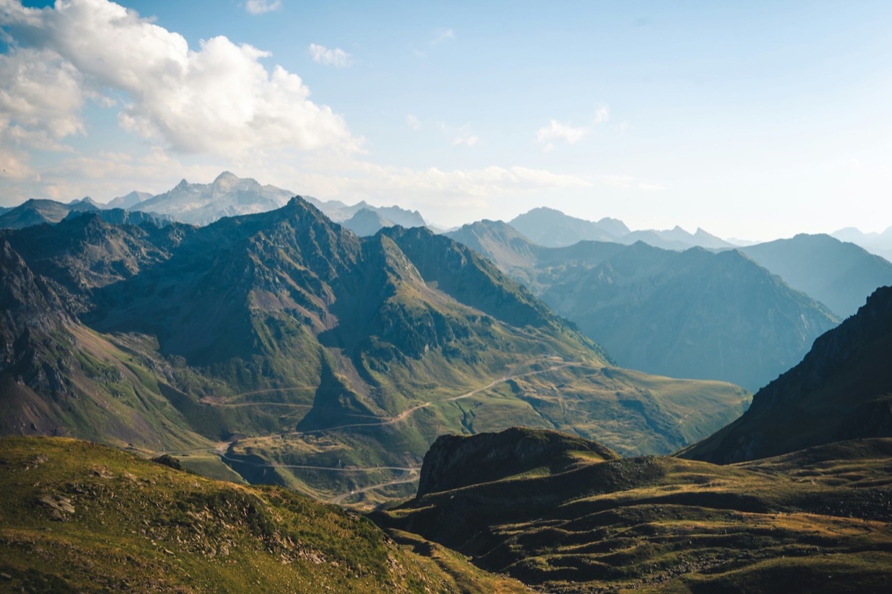 Layered mountain ridges standing vast under an open sky